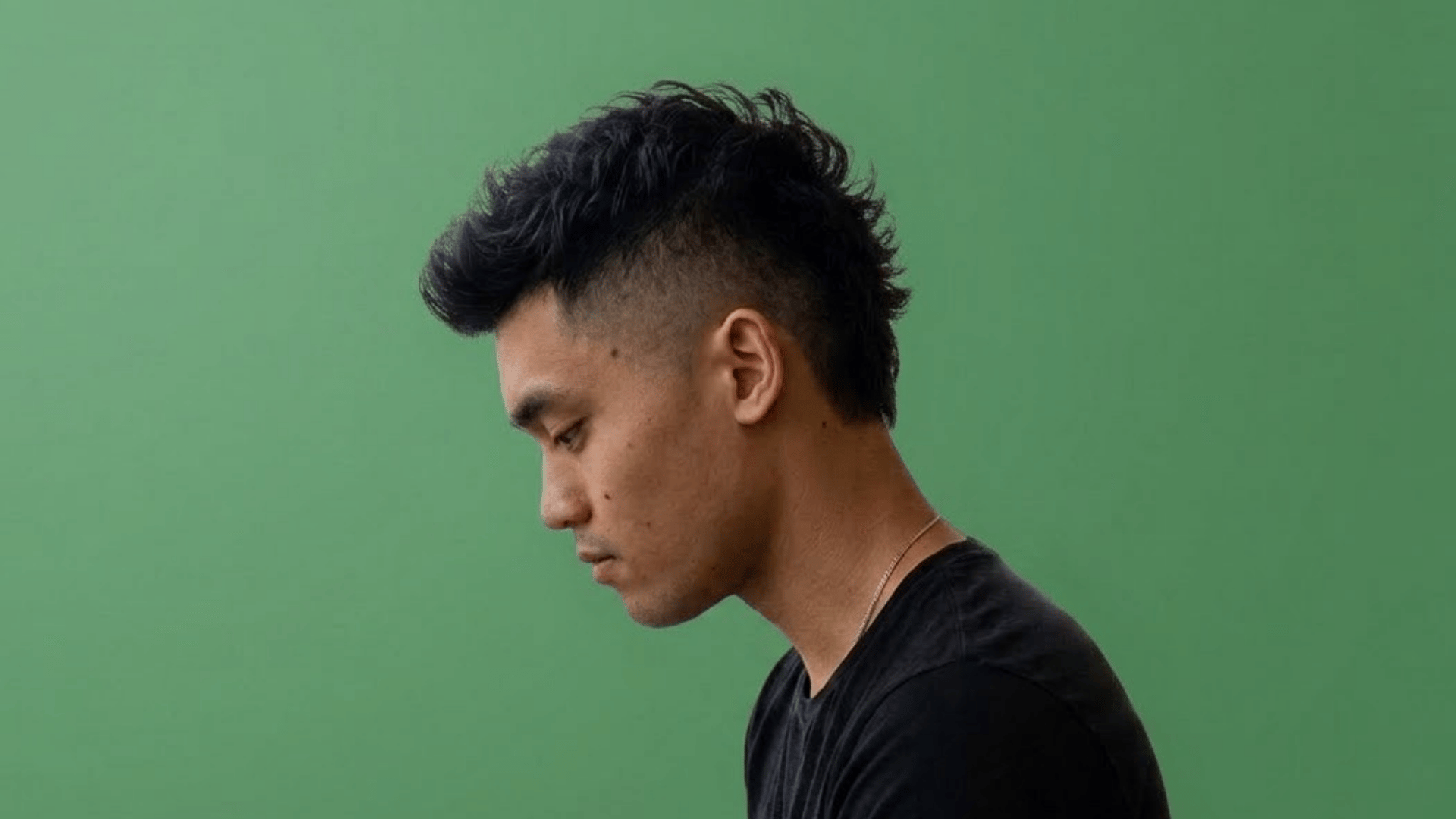 short mohawk with a cropped dark center strip and closely shaved sides
