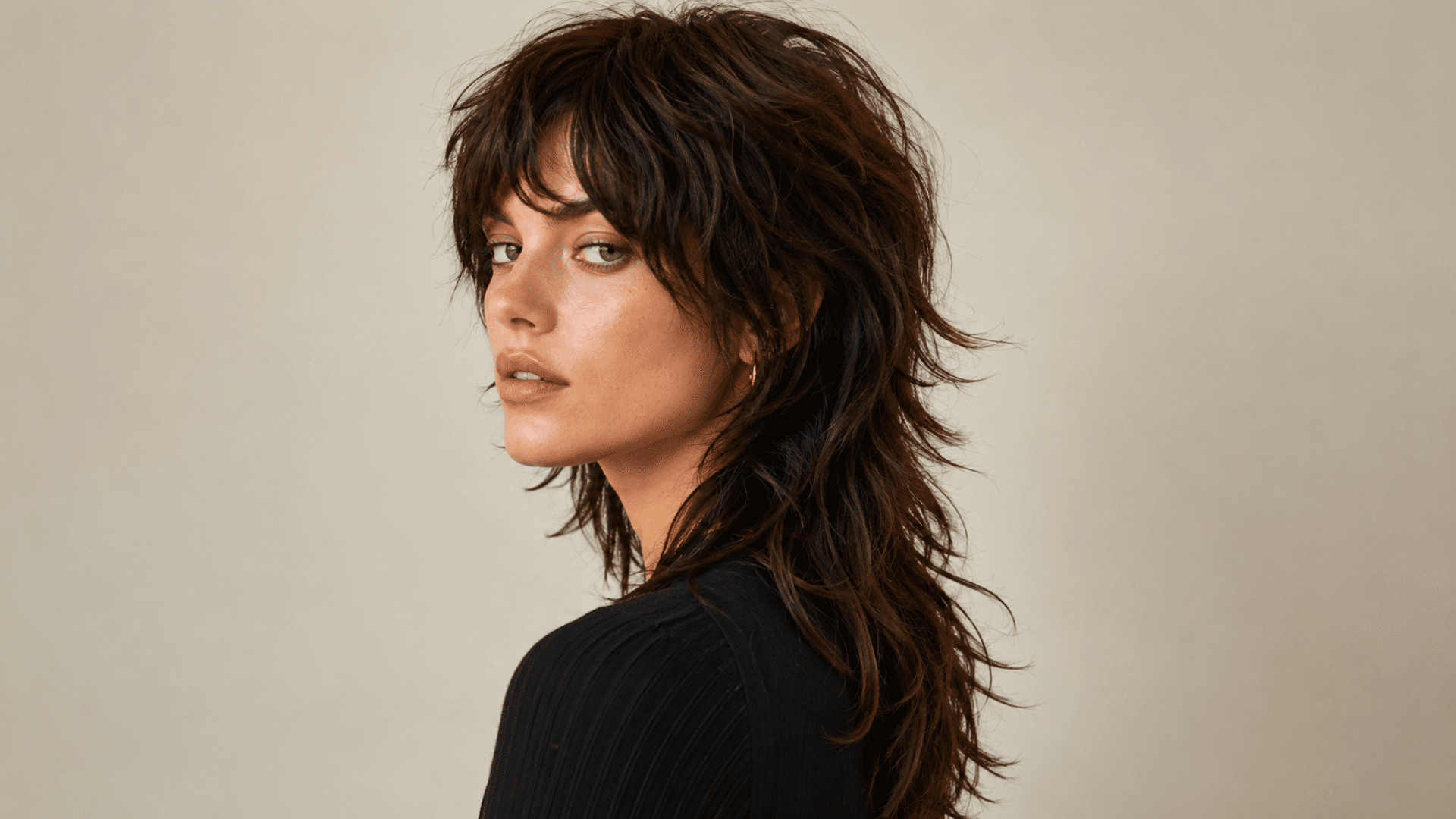 textured brown wolf cut with shaggy layers wispy bangs and longer tapered ends