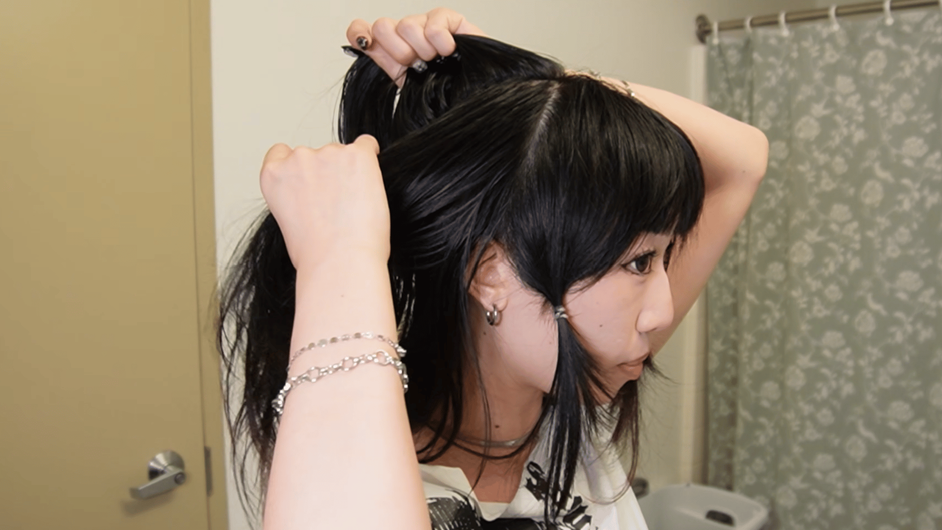 trimming the shorter upper layer to create the rounded shape of a jellyfish haircut