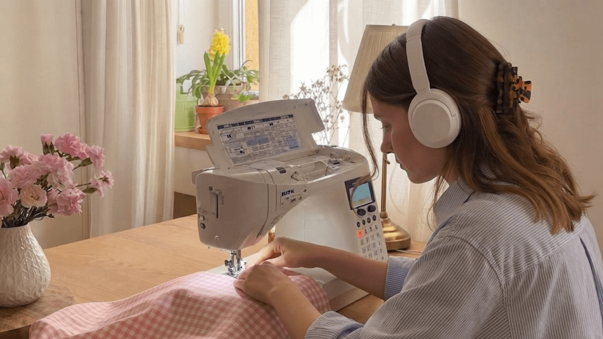 woman sewing and knitting by hand while creating handmade clothing and crafts with yarn and fabric