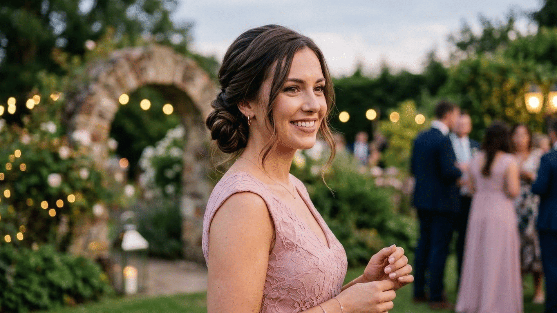 woman wearing elegant side bun hairstyle with soft loose strands for wedding celebration