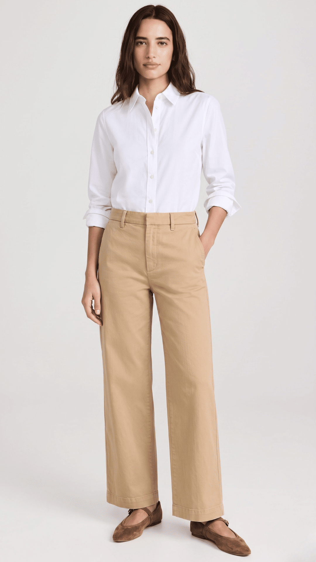 woman wearing khaki pants with a white blouse and loafers for a clean polished everyday outfit