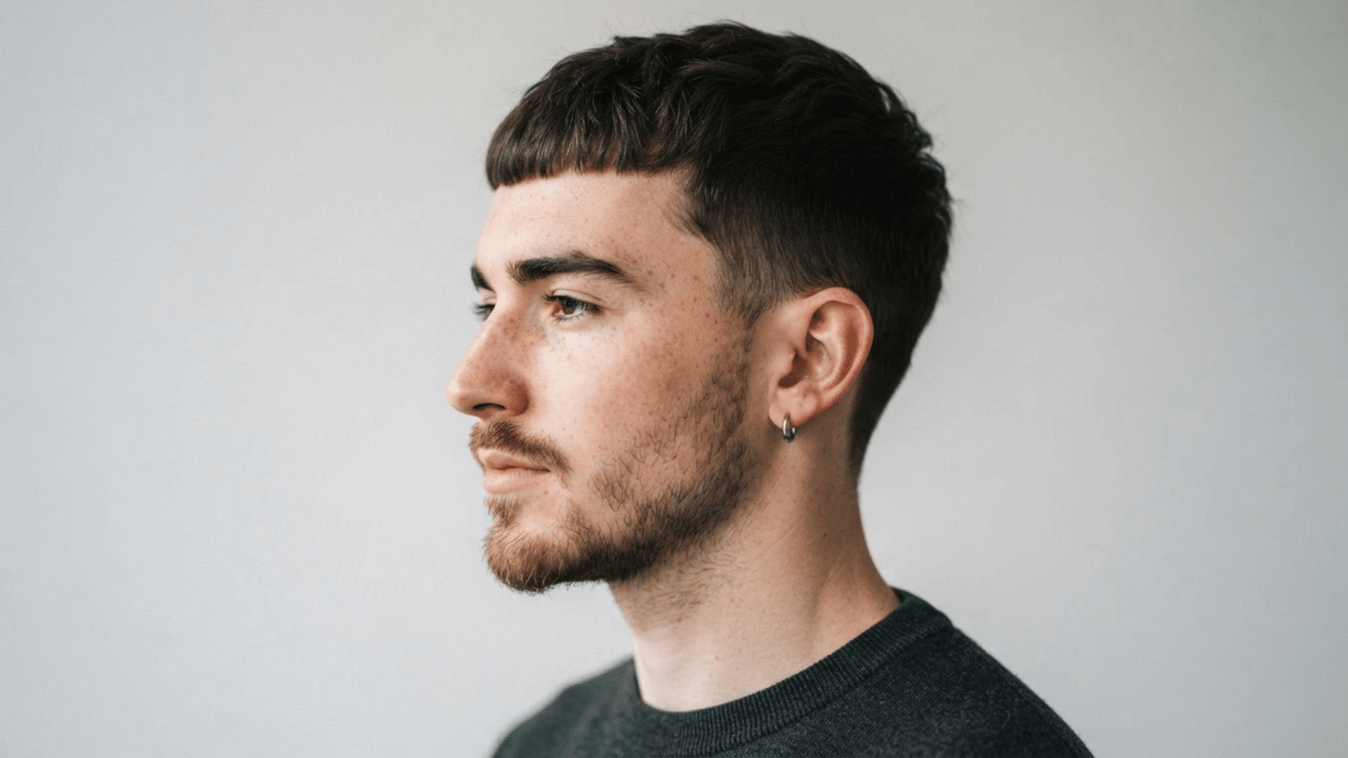 man with thinning hair wearing a French crop with short sides and textured fringe styled forward