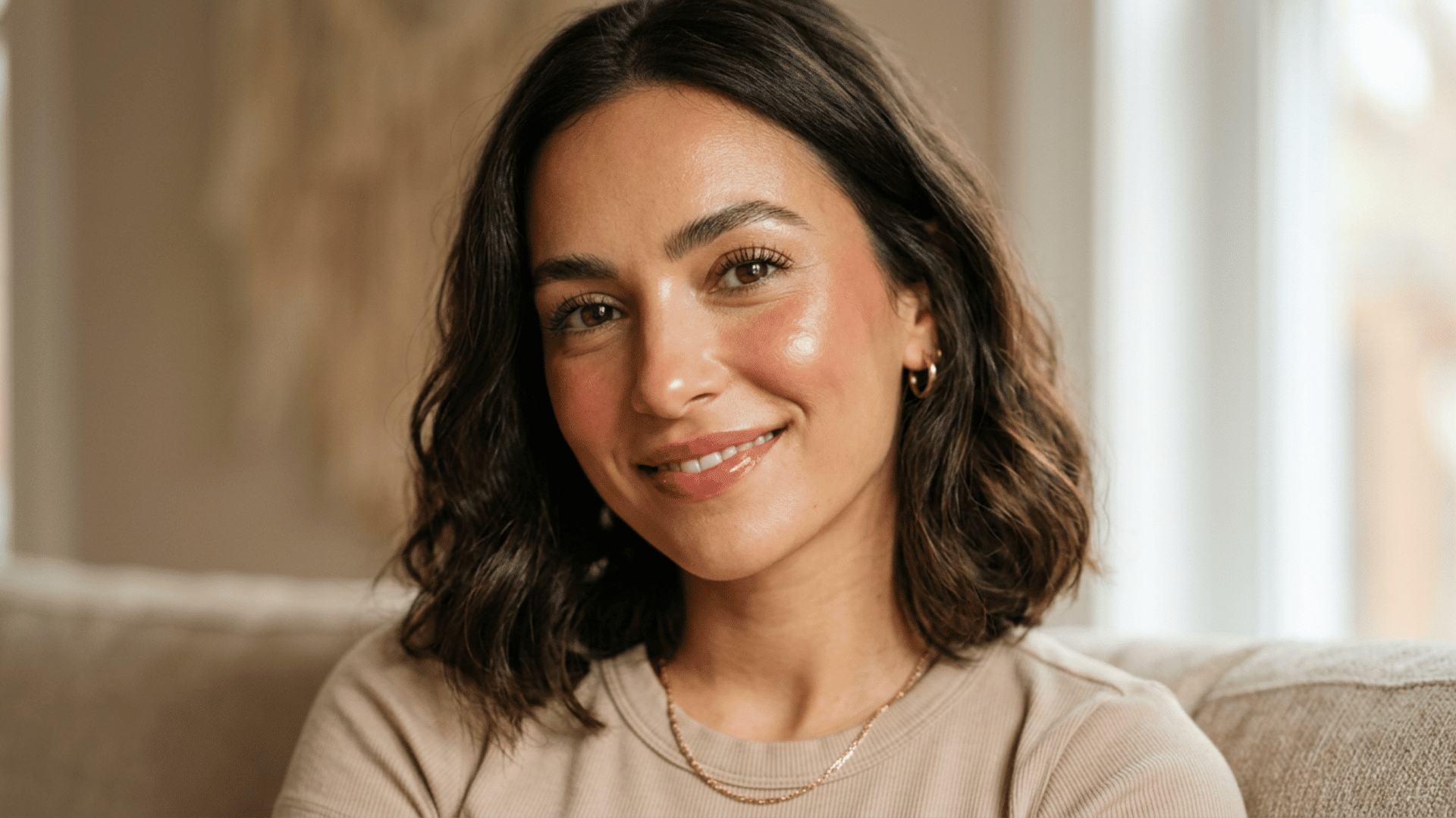 woman wearing glossy natural makeup with luminous cheeks cream blush and clear rose lip gloss