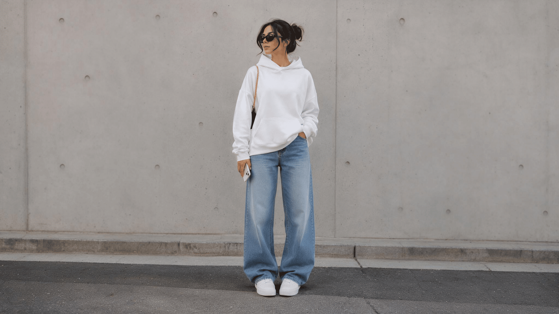 white hoodie with jeans and sneakers creating a relaxed casual everyday outfit look