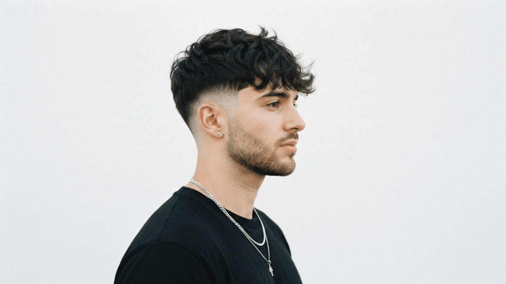 man with thinning hair wearing short sides and a messy textured hairstyle on top
