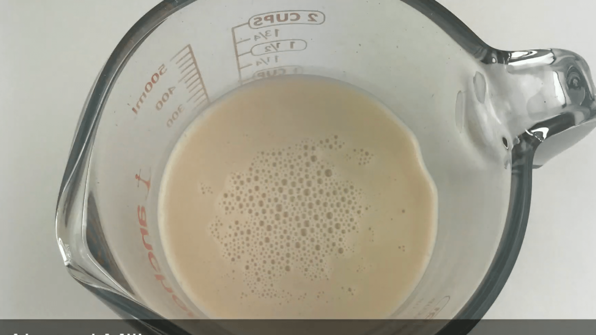 almond milk poured into the blender with frozen peaches to help create a smooth peach smoothie texture