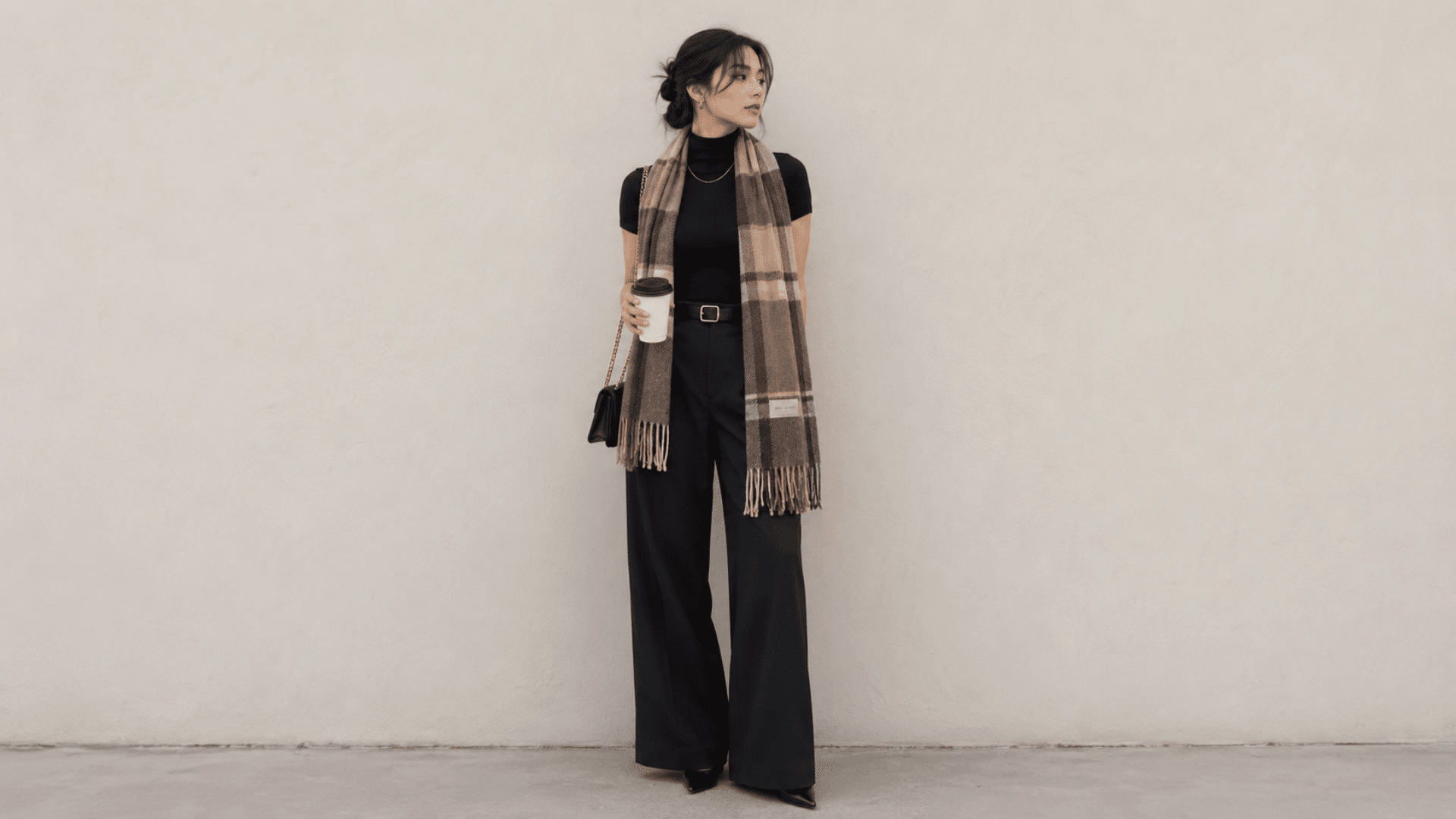 black outfit with scarf and trousers creating an elegant layered cold weather fashion look