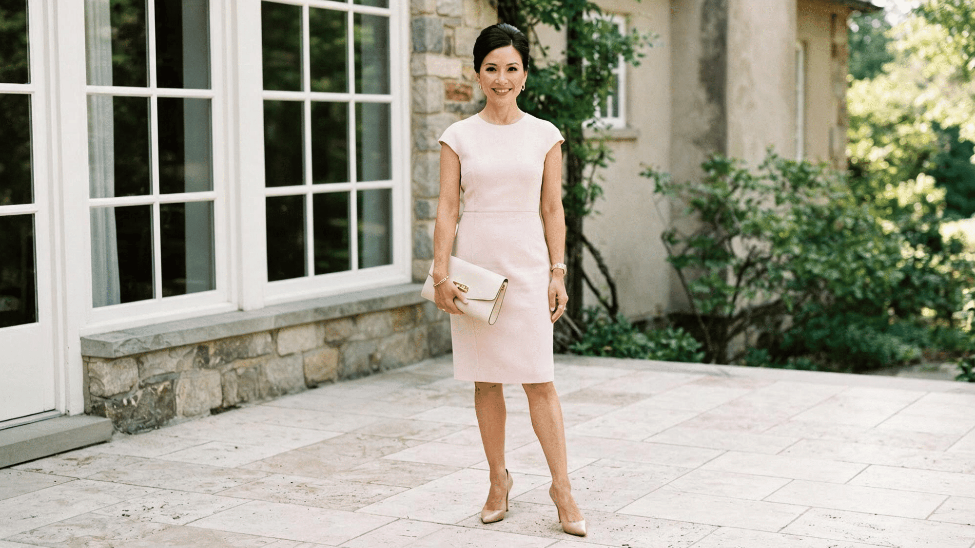 woman wearing a sheath dress with a fitted silhouette that follows the body and creates a polished elegant look