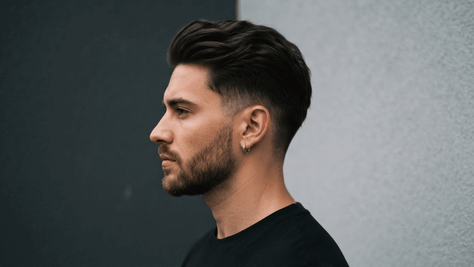 man with thinning hair wearing a short brush-back hairstyle with natural volume and neat sides