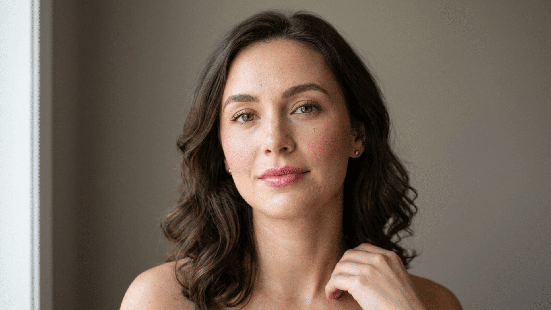 woman wearing soft matte natural makeup with diffused blush brown mascara and light pink lips