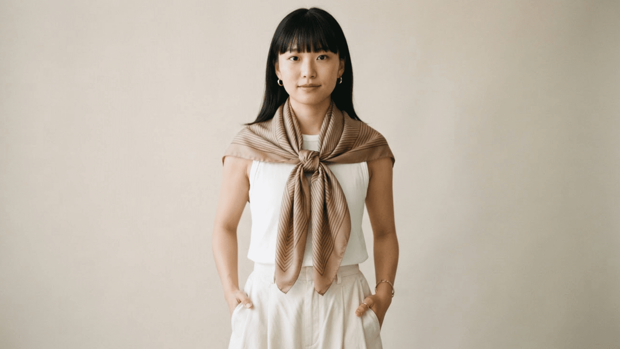scarf tied as a bib creating an elegant flowing look with soft layers and relaxed style