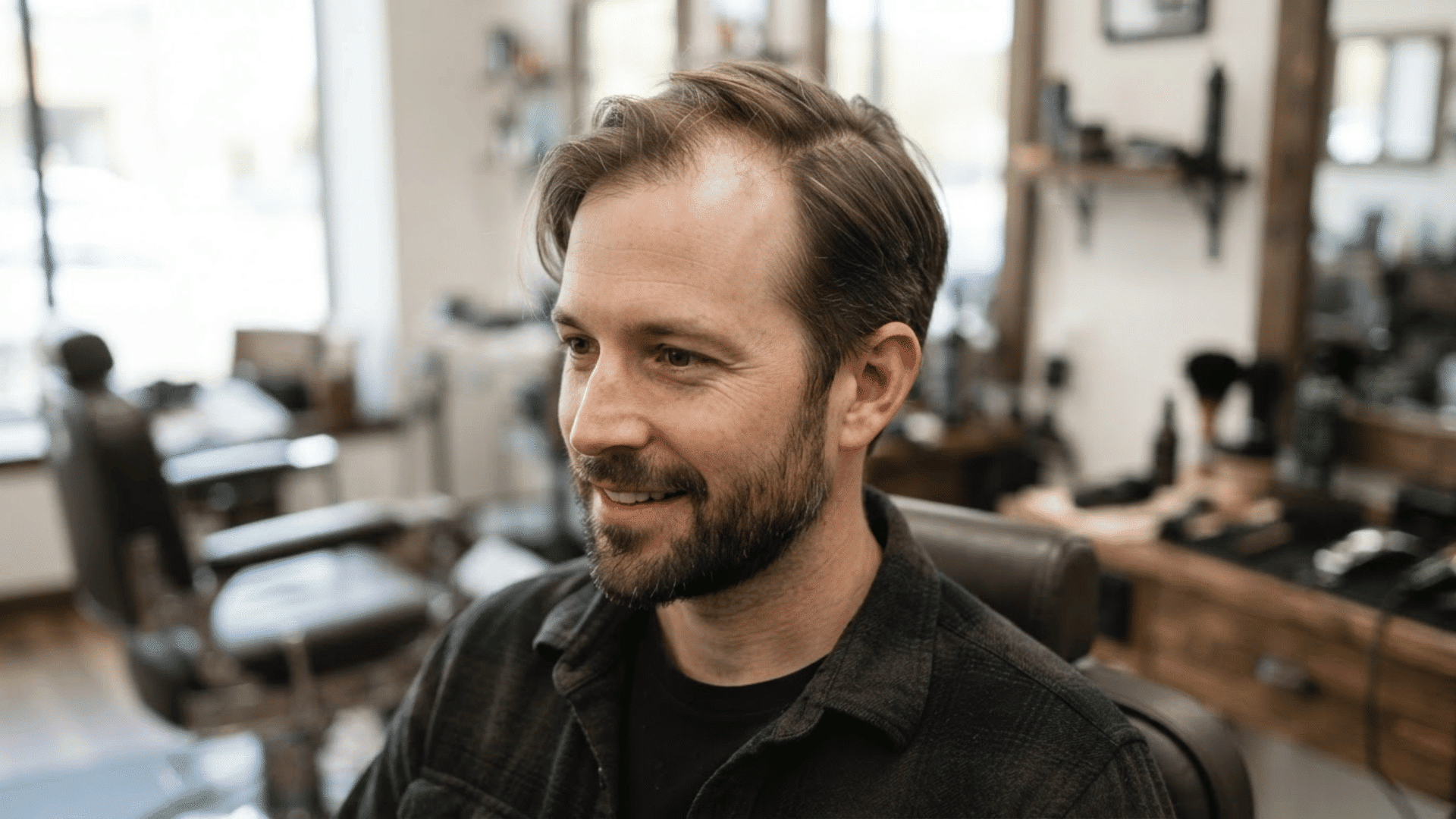 man with thinning hair wearing a short swept-over hairstyle with hair naturally directed to one side
