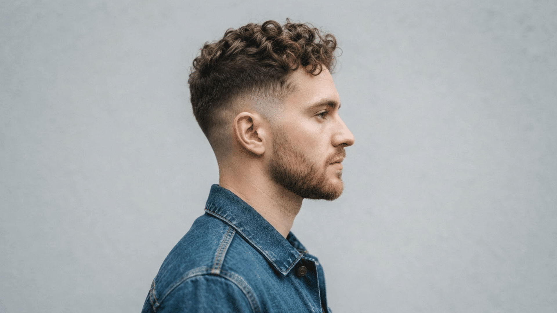 man with thinning hair wearing a taper fade with short sides and textured hair on top