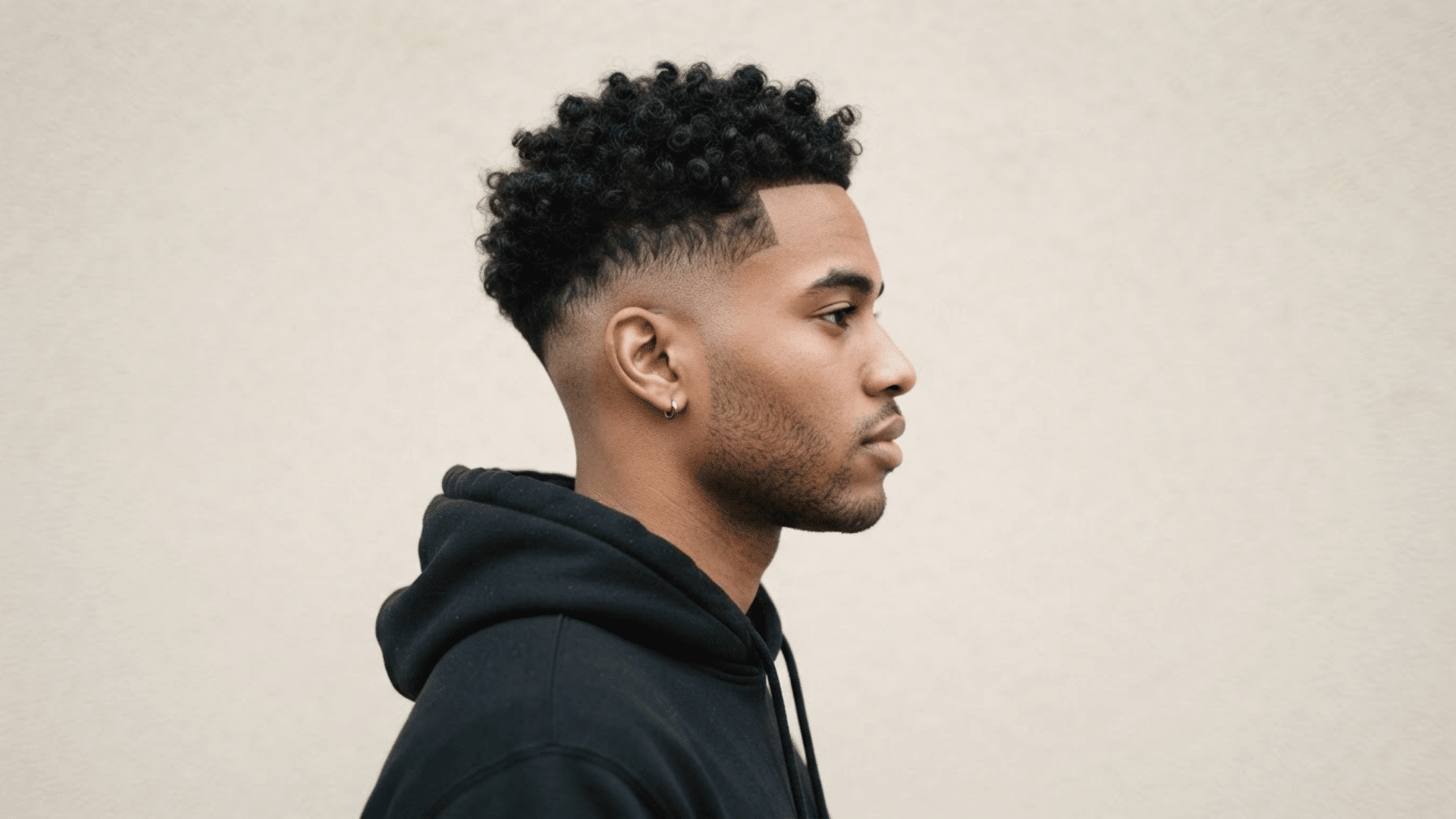 man with thinning hair wearing a short textured crop with neat faded sides and choppy layers on top