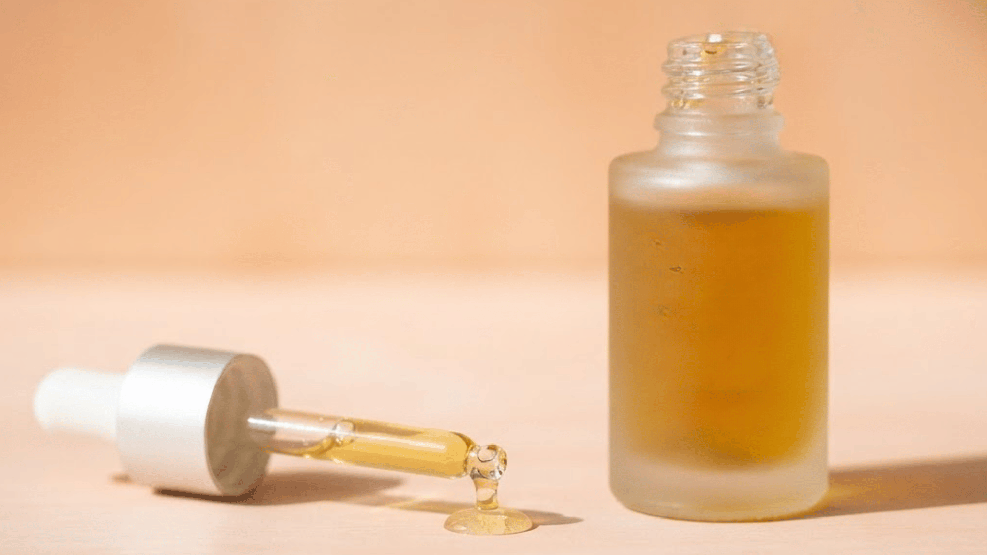 pdrn skincare serum bottle with golden liquid and glass dropper on a neutral background