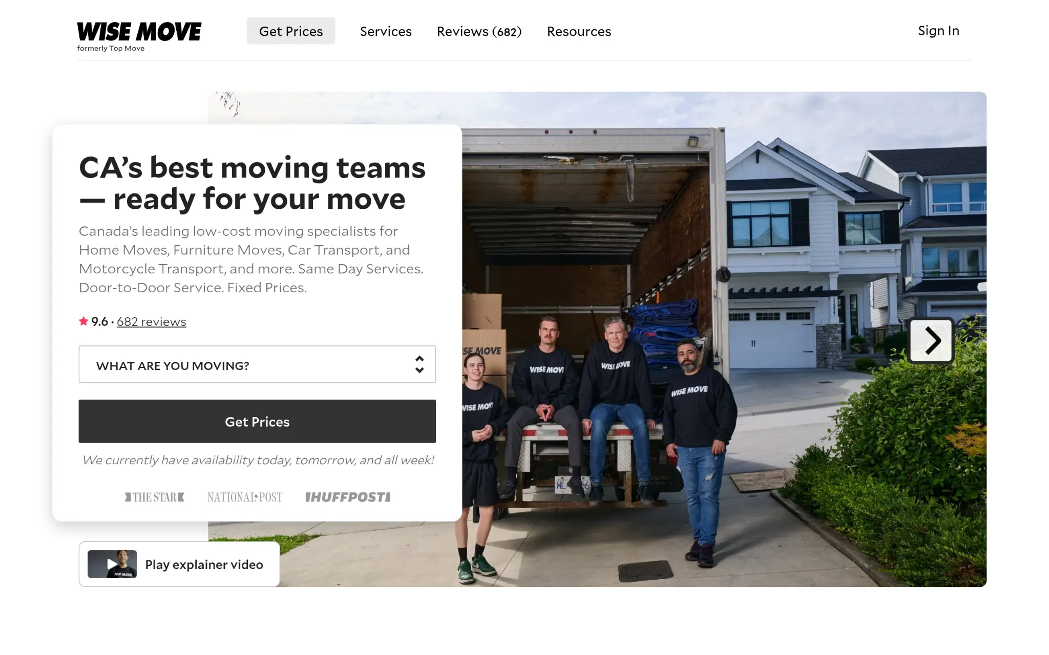 Moving team in matching black sweaters seated on a truck in a suburban driveway